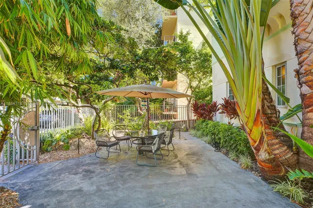 a lawn chair sitting under a blue umbrella
