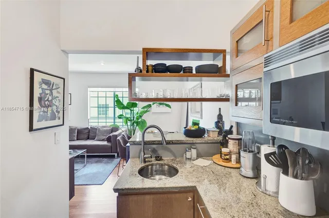 a kitchen with a stove a sink and a microwave