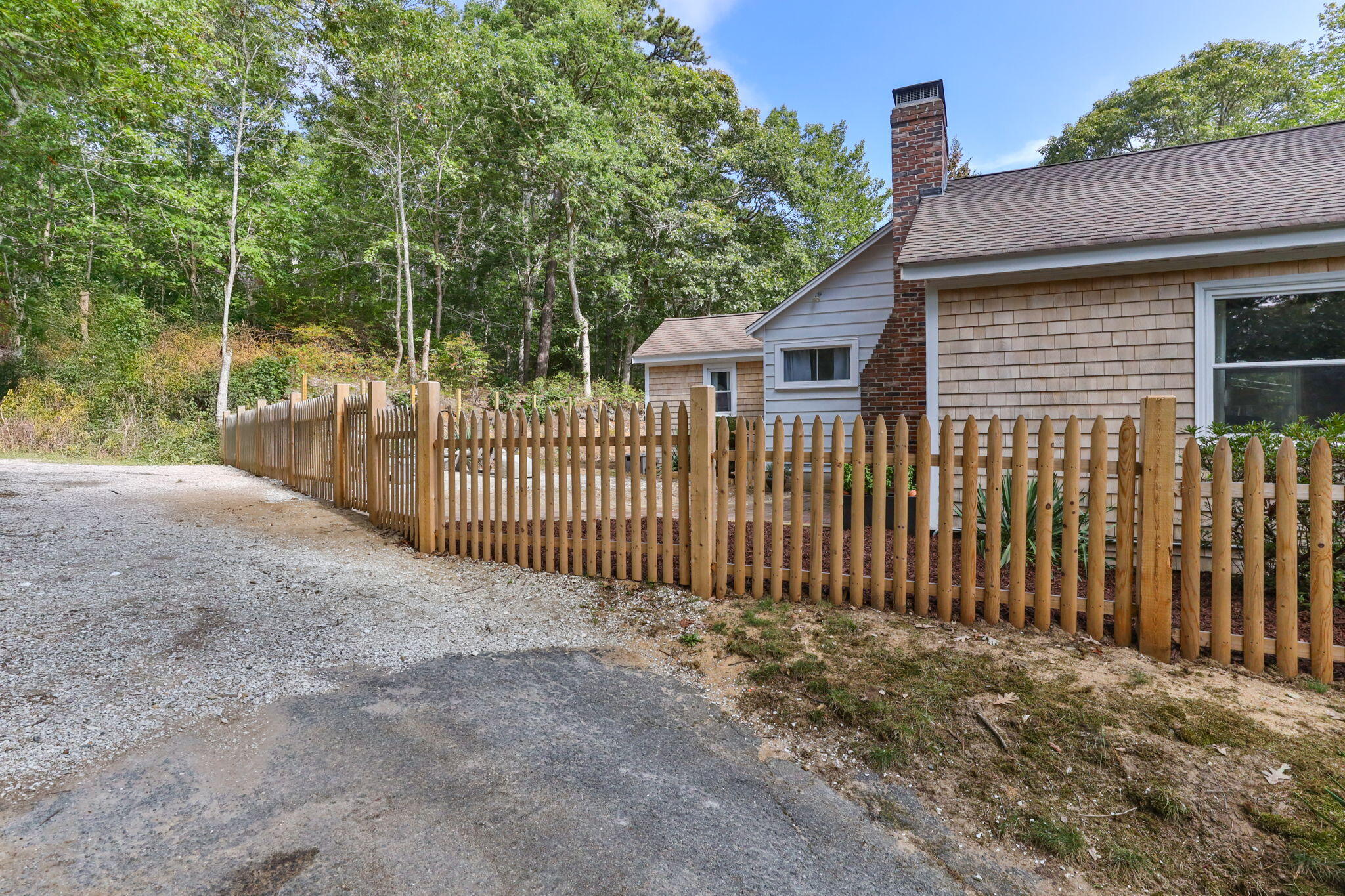 90 Paine Hollow Road Wellfleet, MA 02667 - Photo 26 of 30 a view of a brick house with a small yard and a large tree