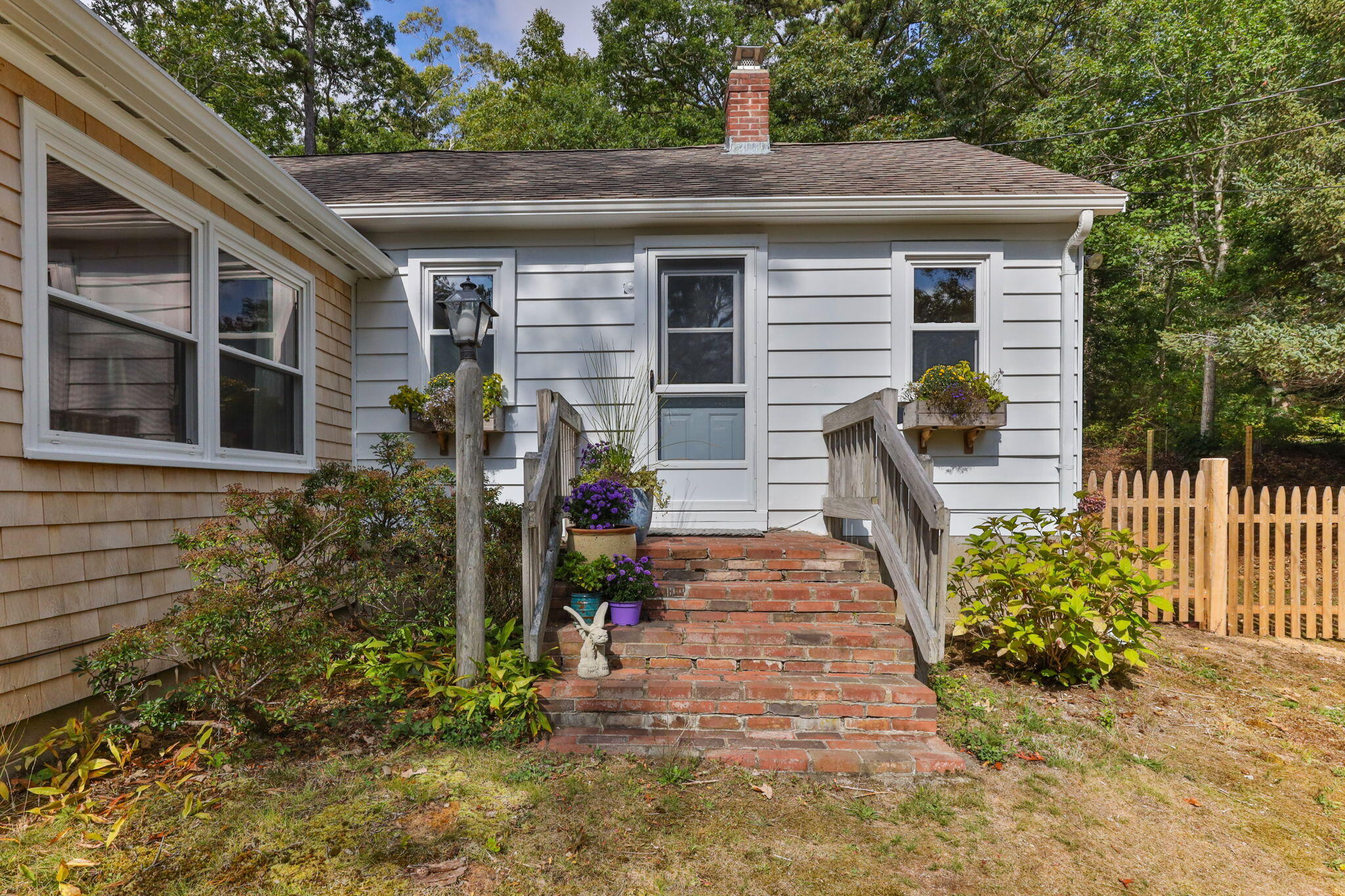 90 Paine Hollow Road Wellfleet, MA 02667 - Photo 3 of 30 a front view of a house with garden