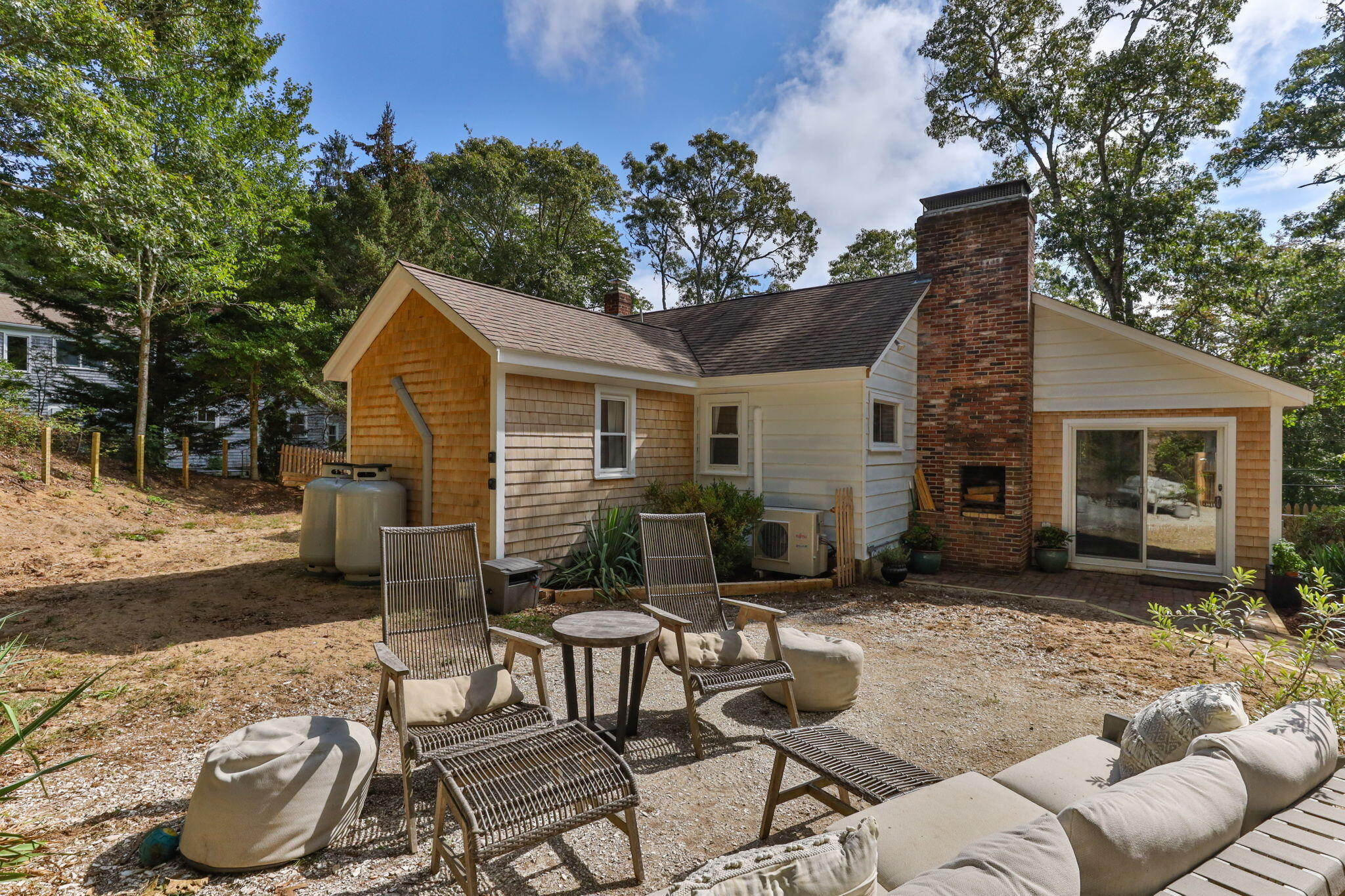 90 Paine Hollow Road Wellfleet, MA 02667 - Photo 6 of 30 a view of a house with backyard couches and chairs