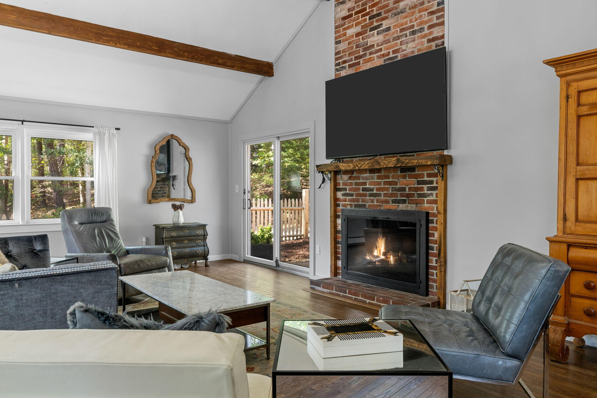 90 Paine Hollow Road Wellfleet, MA 02667 - Photo 8 of 30 a living room with furniture a flat screen tv and a fireplace