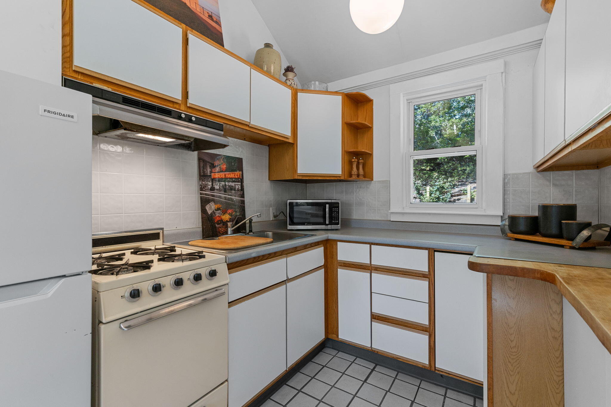 90 Paine Hollow Road Wellfleet, MA 02667 - Photo 9 of 30 a kitchen with granite countertop a sink cabinets stainless steel appliances and a window