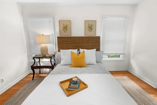 a view of a living room with furniture and wooden floor