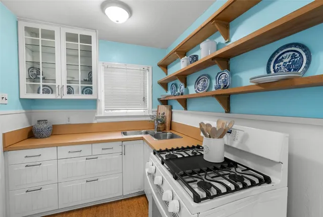 a stove top oven sitting inside of a kitchen