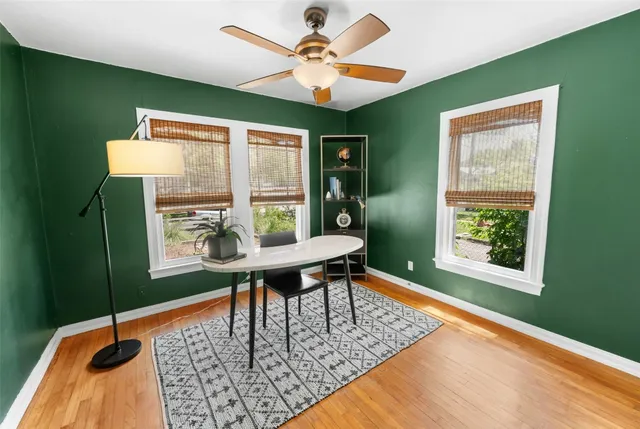 a view of a workspace with furniture and a window