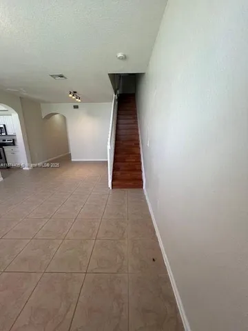 a view of a hallway with wooden walls and stairs