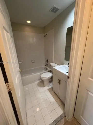 a bathroom with a sink a toilet a mirror and shower