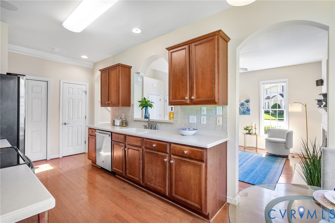 13532 Baycraft Terrace Midlothian, VA 23112 - Photo 12 of 28 a kitchen with stainless steel appliances granite countertop a refrigerator a sink dishwasher and wooden cabinets with wooden floor
