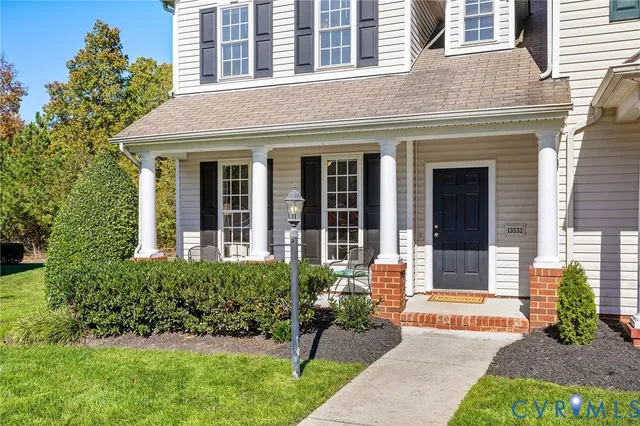 front view of a brick house with a yard