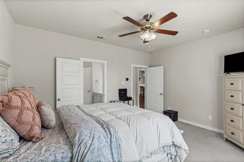 a bedroom with a bed and a television