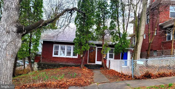 front view of a house with a tree