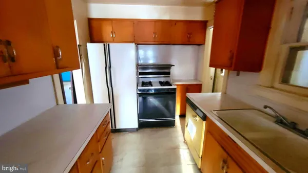 a kitchen with a refrigerator and a sink