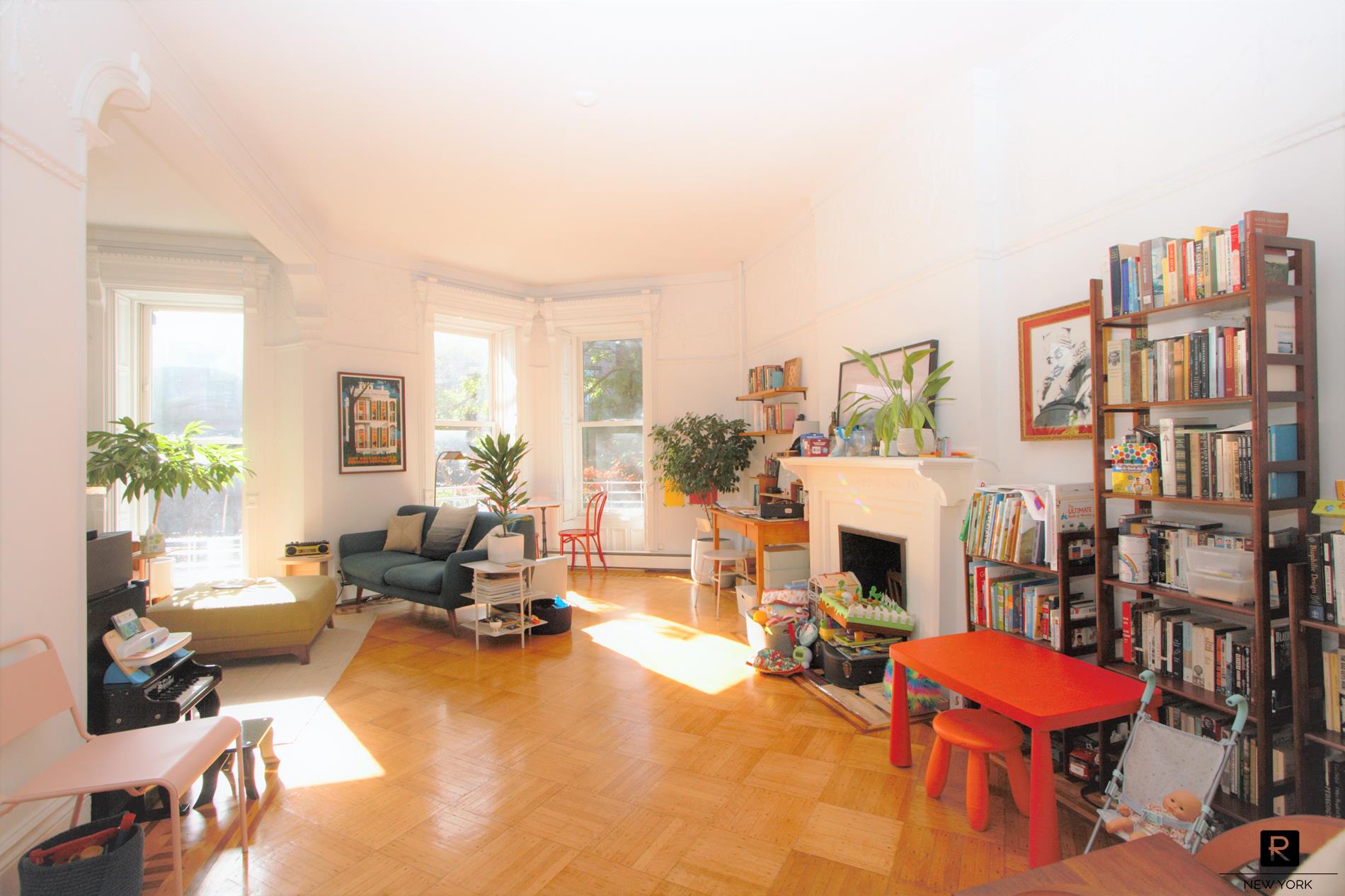 211 Berkeley Place, Unit UPRDPLX Brooklyn, NY 11217 - Photo 1 of 25 a living room with furniture a fireplace and a large mirror with potted plants