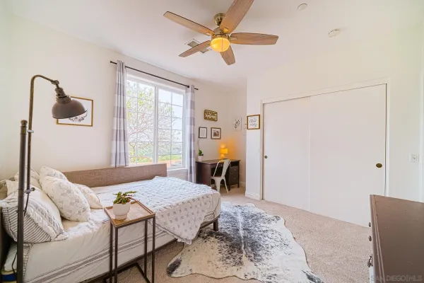 a view of a city with lots of residential buildings ocean and mountain view in back