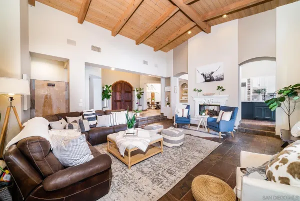 a living room with furniture a fireplace and a table