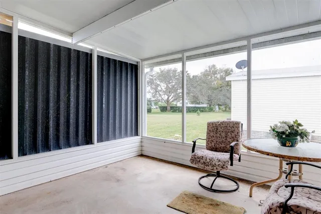 a living room with furniture and a floor to ceiling window