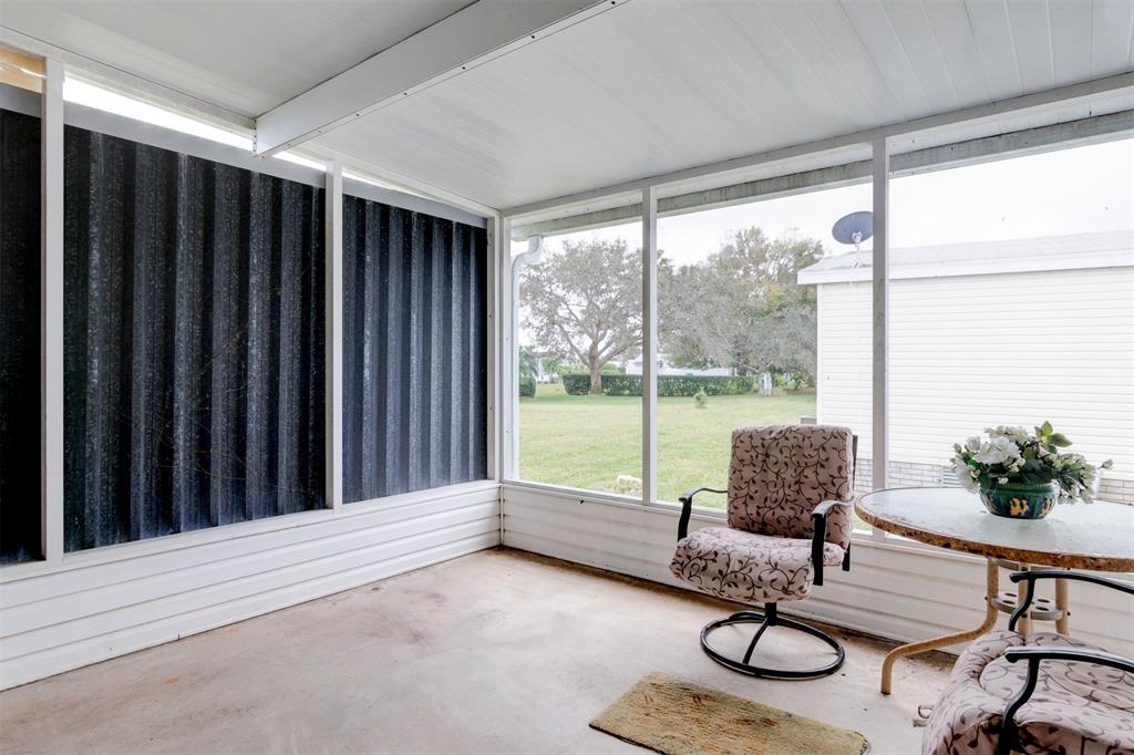 2405 Kelly Sebastian, FL 32958 - Photo 16 of 17 a living room with furniture and a floor to ceiling window