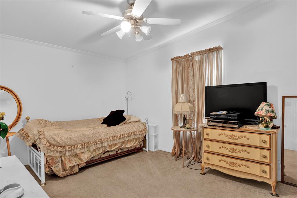 2405 Kelly Sebastian, FL 32958 - Photo 9 of 17 a bedroom with a bed and a flat tv screen on dresser