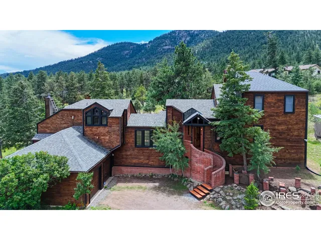 a backyard of a house with a yard and mountain view in back