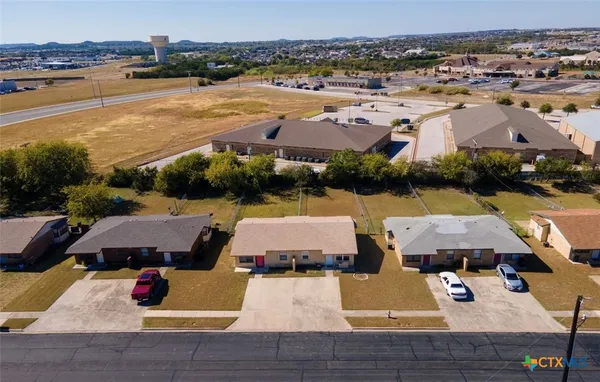 an aerial view of houses with yard