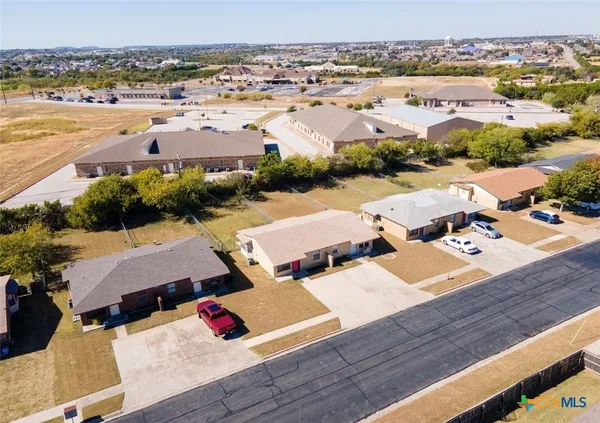an aerial view of residential houses with outdoor space