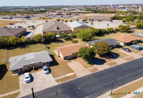 an aerial view of residential houses with outdoor space