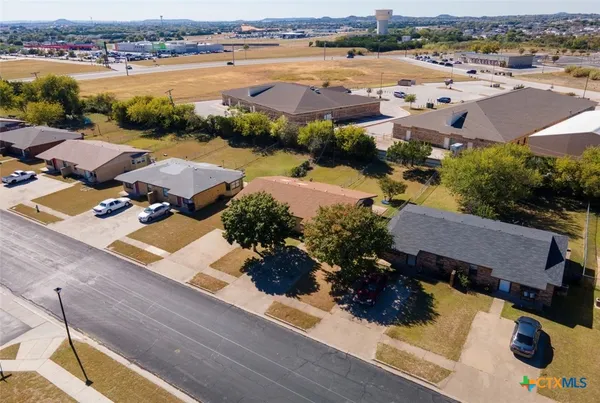 an aerial view of residential houses with outdoor space and river