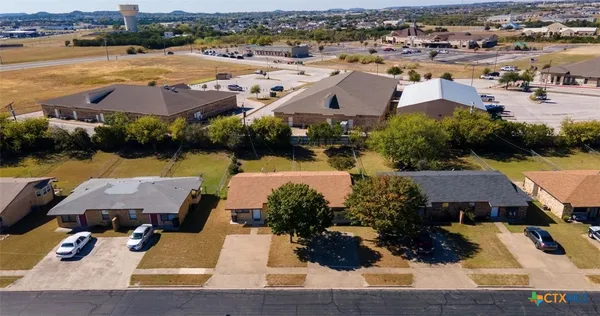 an aerial view of a house with outdoor space and lake view