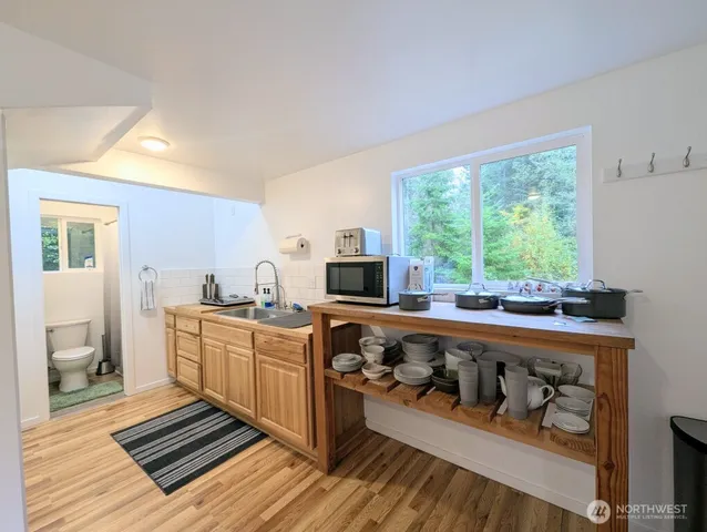 a kitchen with a large window appliances and cabinets