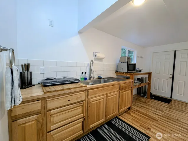 a kitchen with stainless steel appliances a stove refrigerator and cabinets