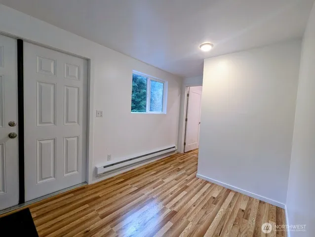 a view of an empty room with wooden floor
