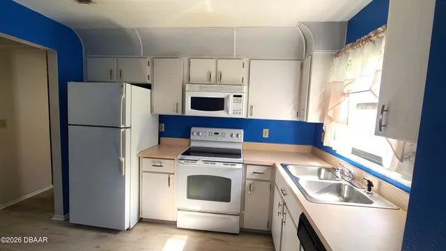 an empty room with wooden floor and a window
