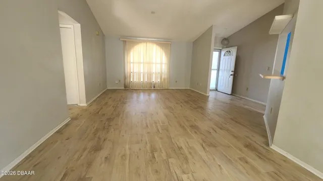wooden floor in an empty room with a window