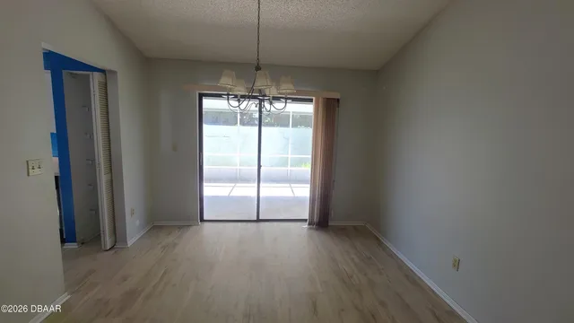 an empty room with a ceiling fan and a window