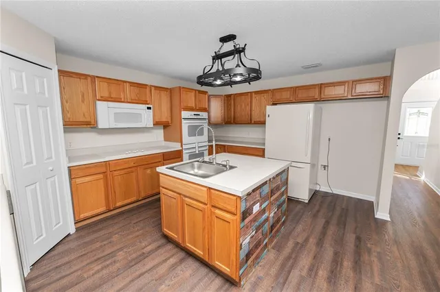 a kitchen with a sink stove and cabinets