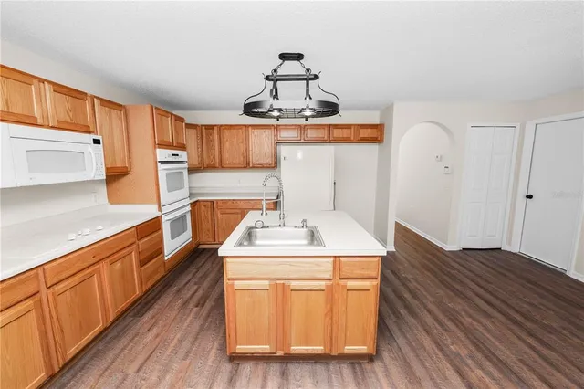 a view of a hallway with wooden floor and closet
