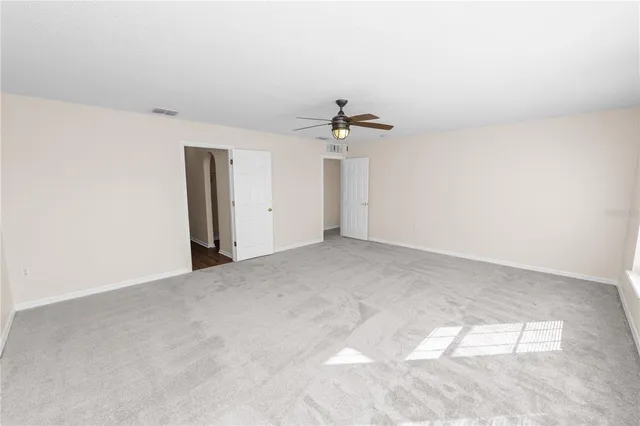 an empty room with windows and closet