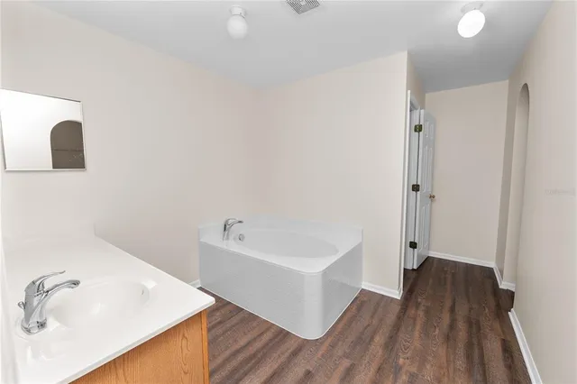 an empty room with a ceiling fan and carpet