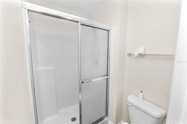 an empty room with a window and a ceiling fan