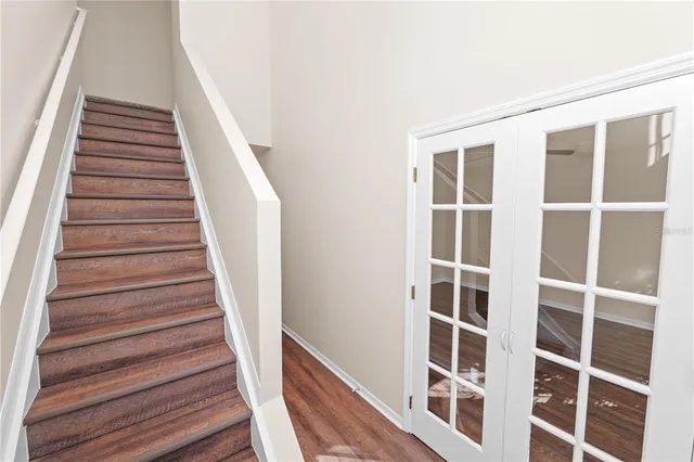 a view of staircase with wooden floor and windows