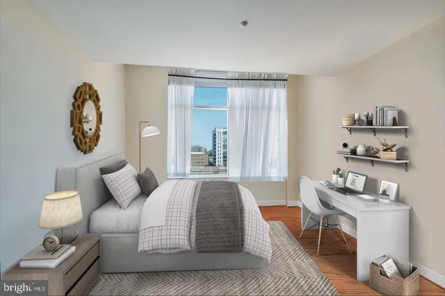 a bedroom with a bed and a table in it