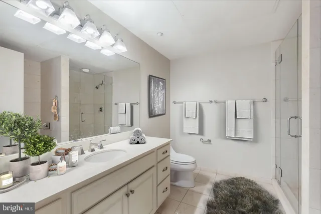 a bathroom with a granite countertop sink mirror and vanity