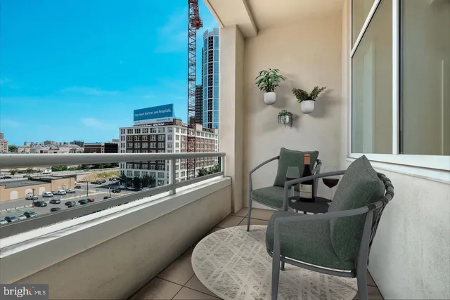 a dining room with furniture and a floor to ceiling window