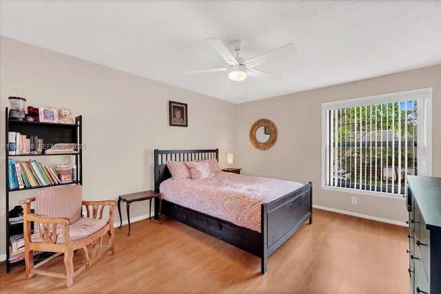 a bedroom with a bed and a book shelf