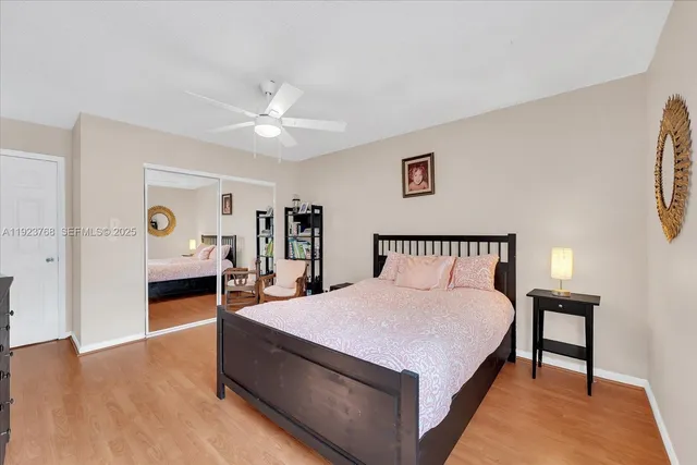 a spacious bedroom with a bed and a chandelier