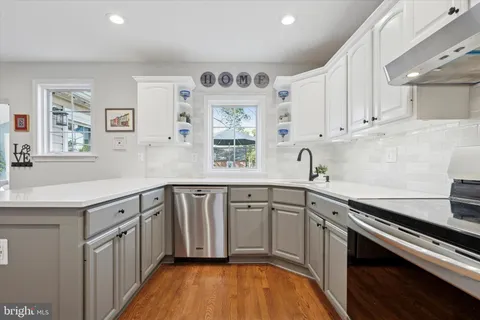 a kitchen with cabinets a sink and appliances