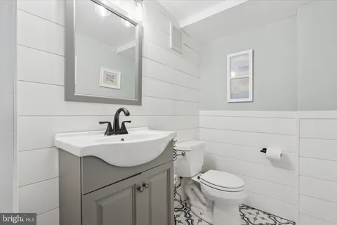 a bathroom with a sink a toilet and mirror