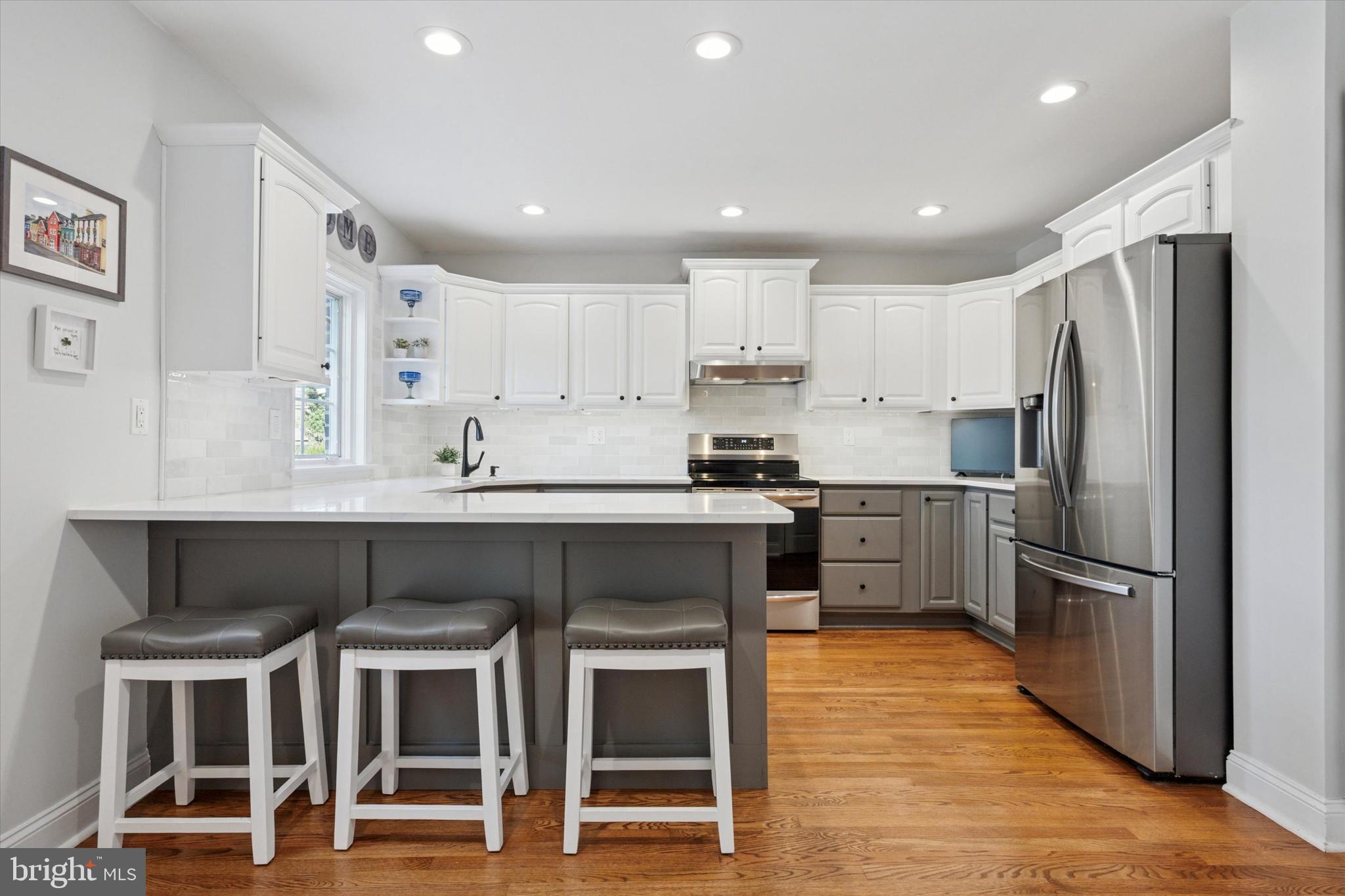 141 Friendship Road Drexel Hill, PA 19026 - Photo 10 of 34 a kitchen with stainless steel appliances kitchen island granite countertop a refrigerator and a stove top oven