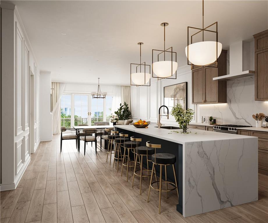 5804 Bryant Street, Unit 201 Pittsburgh, PA 15206 - Photo 3 of 6 a kitchen with stainless steel appliances granite countertop a table chairs stove and wooden floor